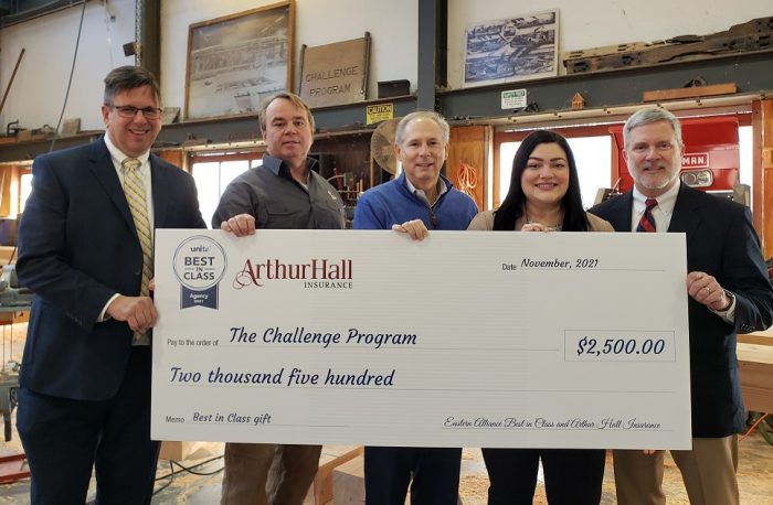The Challenge Program donation check presentation with representatives from Eastern Alliance, The Challenge Program and Arthur Hall Insurance