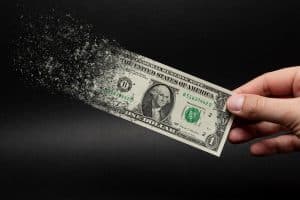 dollar bill slipping away due to inflation