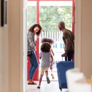 family ready to leave for vacation with luggage